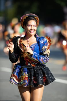 Washington, D.C., USA - September 29, 2018: The Fiesta DC Parade, Bolivian women wearing traditional clothing performing a traditional dance from bolivia