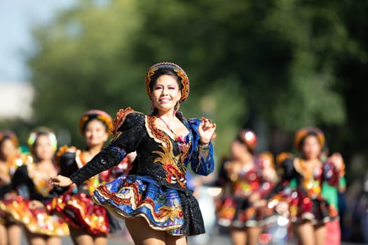 Washington, D.C., USA - September 29, 2018: The Fiesta DC Parade, Bolivian women wearing traditional clothing performing a traditional dance from bolivia