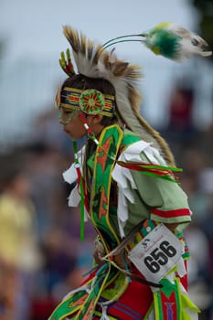 Milwaukee, Wisconsin, USA - September 8, 2018 The Indian Summer Festival, Child wearing traditional native american clothing, dancing at the pow wow competition.