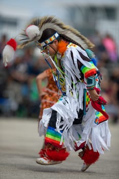 Milwaukee, Wisconsin, USA - September 8, 2018 The Indian Summer Festival, Child wearing traditional native american clothing, dancing at the pow wow competition.