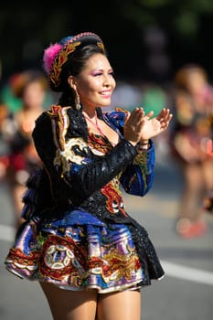 Washington, D.C., USA - September 29, 2018: The Fiesta DC Parade, Bolivian women wearing traditional clothing performing a traditional dance from bolivia