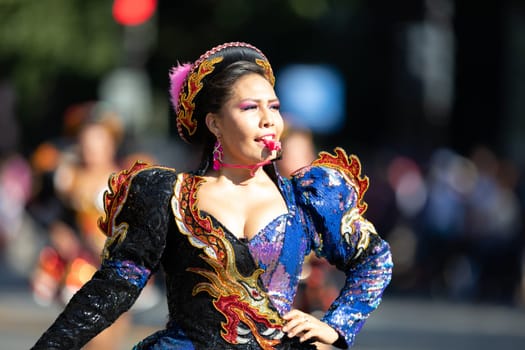 Washington, D.C., USA - September 29, 2018: The Fiesta DC Parade, Bolivian women wearing traditional clothing performing a traditional dance from bolivia