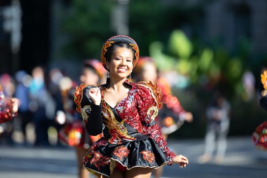 Washington, D.C., USA - September 29, 2018: The Fiesta DC Parade, Bolivian women wearing traditional clothing performing a traditional dance from bolivia