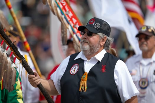 Milwaukee, Wisconsin, USA - September 8, 2018 The Indian Summer Festival, Men and women wearing traditional native american clothing in the ceremony honoring native american military veterans