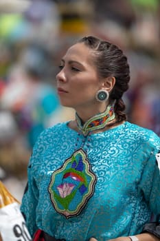Milwaukee, Wisconsin, USA - September 8, 2018 The Indian Summer Festival Young woman wearing traditional native american clothing at the pow wow competition.