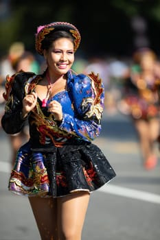 Washington, D.C., USA - September 29, 2018: The Fiesta DC Parade, Bolivian women wearing traditional clothing performing a traditional dance from bolivia