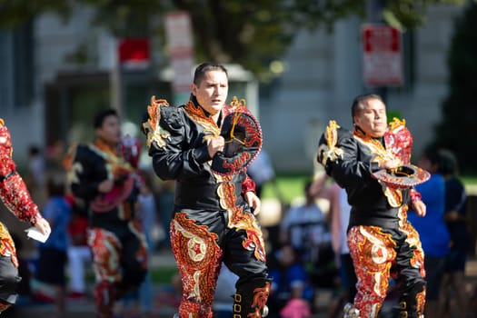 Washington, D.C., USA - September 29, 2018: The Fiesta DC Parade, Bolivian men wearing traditional clothing performing a traditional Bolivian dance