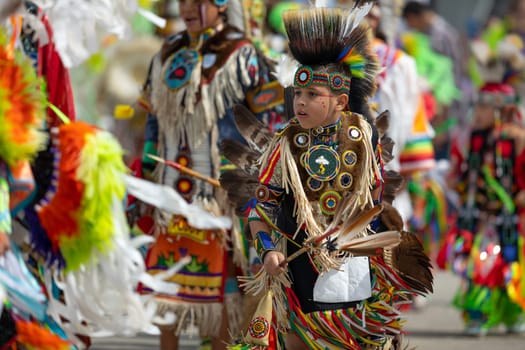 Milwaukee, Wisconsin, USA - September 8, 2018 The Indian Summer Festival, Child wearing traditional native american clothing, dancing at the pow wow competition.