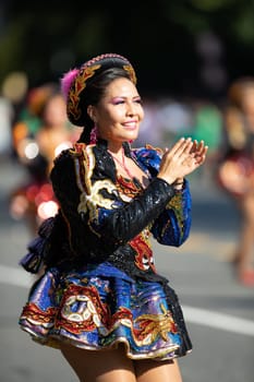 Washington, D.C., USA - September 29, 2018: The Fiesta DC Parade, Bolivian women wearing traditional clothing performing a traditional dance from bolivia