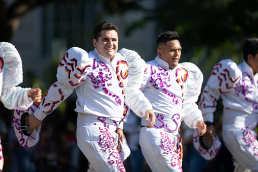 Washington, D.C., USA - September 29, 2018: The Fiesta DC Parade, Bolivian men wearing traditional clothing performing a traditional Bolivian dance