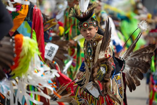 Milwaukee, Wisconsin, USA - September 8, 2018 The Indian Summer Festival, Child wearing traditional native american clothing, dancing at the pow wow competition.