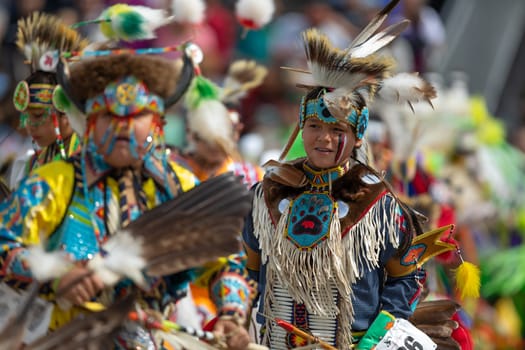 Milwaukee, Wisconsin, USA - September 8, 2018 The Indian Summer Festival, Child wearing traditional native american clothing, dancing at the pow wow competition.