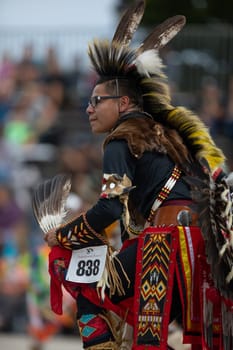 Milwaukee, Wisconsin, USA - September 8, 2018 The Indian Summer Festival, Man wearing traditional native american clothing, dancing at the pow wow competition.