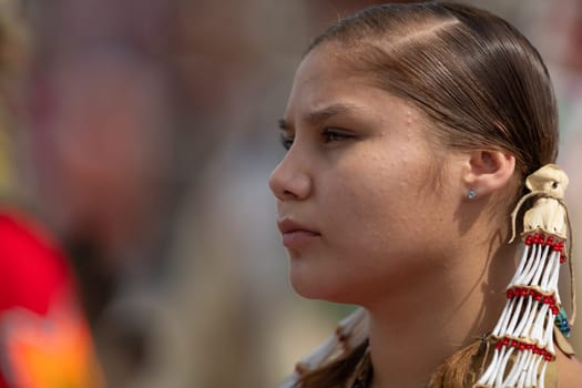Milwaukee, Wisconsin, USA - September 8, 2018 The Indian Summer Festival Young woman wearing traditional native american clothing at the pow wow competition.