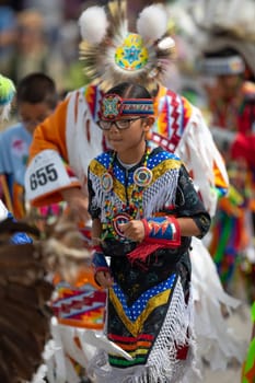 Milwaukee, Wisconsin, USA - September 8, 2018 The Indian Summer Festival, Girl wearing traditional native american clothing, Dancing at the pow wow competition.