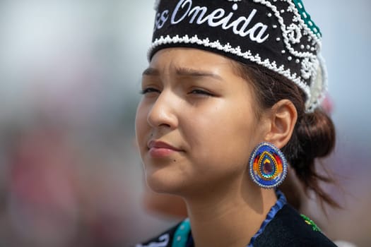 Milwaukee, Wisconsin, USA - September 8, 2018 The Indian Summer Festival Young woman wearing traditional native american clothing at the pow wow competition.