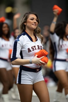 Houston, Texas, USA - November 22, 2018 The H-E-B Thanksgiving Day Parade, Cheerleaders from the Astros Baseball team giving spectators free shirts