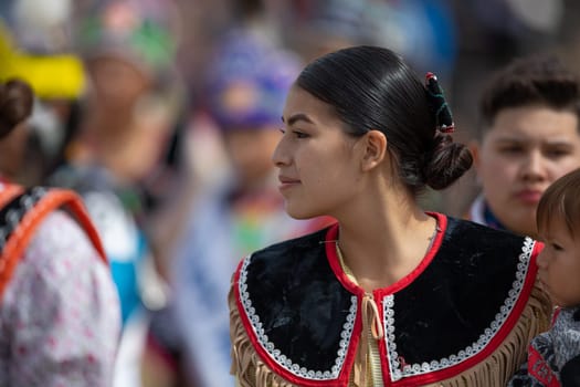 Milwaukee, Wisconsin, USA - September 8, 2018 The Indian Summer Festival Young woman wearing traditional native american clothing at the pow wow competition.