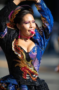 Washington, D.C., USA - September 29, 2018: The Fiesta DC Parade, Bolivian women wearing traditional clothing performing a traditional dance from bolivia
