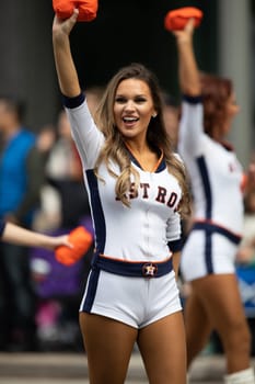 Houston, Texas, USA - November 22, 2018 The H-E-B Thanksgiving Day Parade, Cheerleaders from the Astros Baseball team giving spectators free shirts