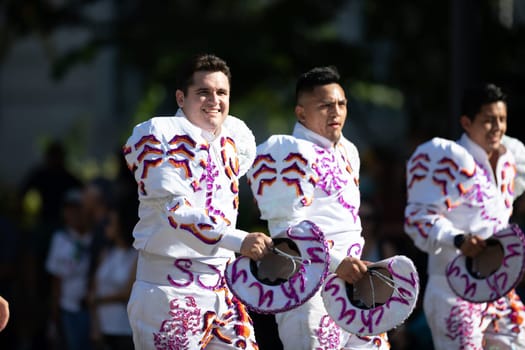 Washington, D.C., USA - September 29, 2018: The Fiesta DC Parade, Bolivian men wearing traditional clothing performing a traditional Bolivian dance