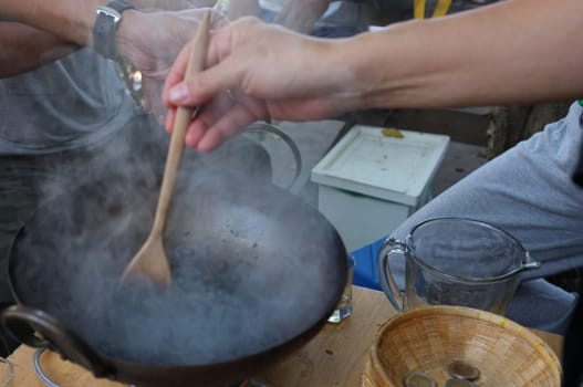 The man roasted coffee beans in pan
