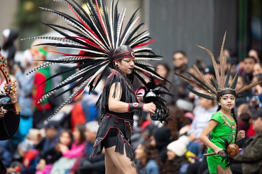 Houston, Texas, USA - November 22, 2018 The H-E-B Thanksgiving Day Parade, Men and women wearing aztec clothing dancing at the parade