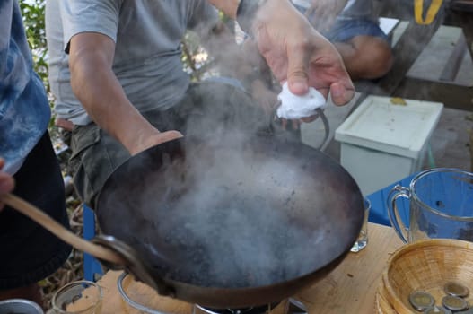 The man roasted coffee beans in pan