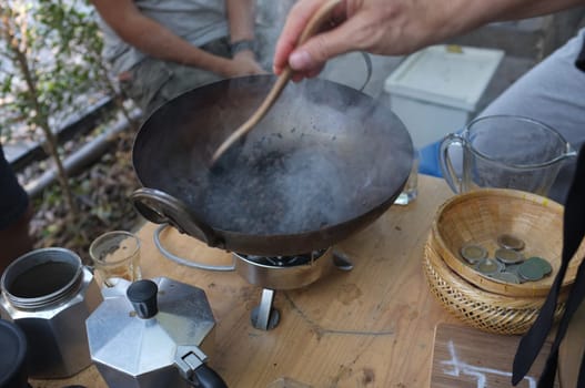 The man roasted coffee beans in pan