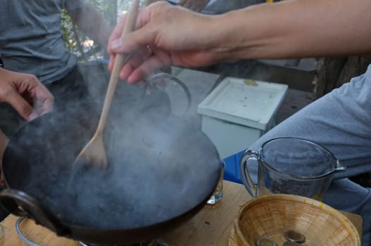 The man roasted coffee beans in pan