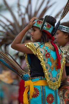 Milwaukee, Wisconsin, USA - September 8, 2018 The Indian Summer Festival, Girl wearing traditional aztec clothing at the Pow Wow competition.