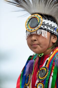 Milwaukee, Wisconsin, USA - September 8, 2018 The Indian Summer Festival, Child wearing traditional native american clothing, dancing at the pow wow competition.