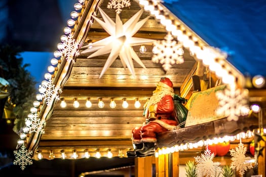 Christmas decoration with a seated Santa Claus and many electric light bulbs