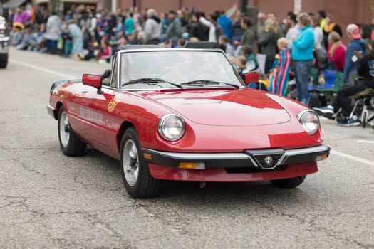 Holland, Michigan, USA - May 12, 2018 An Alfa Romeo Graduate classic car with a sign on it is door that say Rotary Club Of Holland at the Muziek Parade, during the Tulip Time Festival