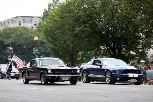Washington, D.C., USA - July 4, 2018, The National Independence Day Parade, A group of Ford Mustangs sports car going down constitution avenue during the parade