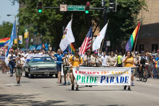 Chicago, Illinois, USA - June 24, 2018 People carry the American and the Rainbow flags during the LGBTQ Pride Parade in Chicago