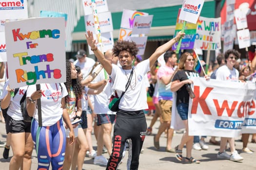 Chicago, Illinois, USA - June 24, 2018 People promoting Kwame for attorney general and lgbtq rights during the LGBTQ Pride Parade in Chicago