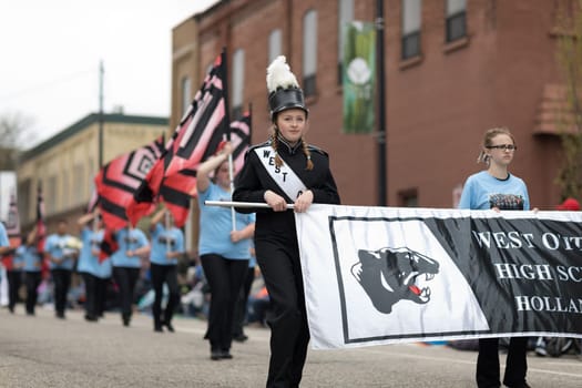 Holland, Michigan, USA - May 12, 2018 Members of the West Ottawa High School Marching Band, Holland MI, perform at the Muziek Parade, during the Tulip Time Festival