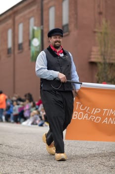 Holland, Michigan, USA - May 12, 2018 Man wearing traditional dutch clothing looks and smiles at the camera at the Muziek Parade, during the Tulip Time Festival