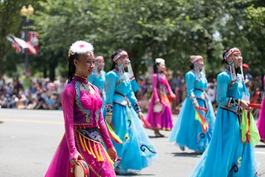 Washington, D.C., USA - July 4, 2018, The National Independence Day Parade, Chinese women wearing traditional clothing, walking down constitution avenue during the parade