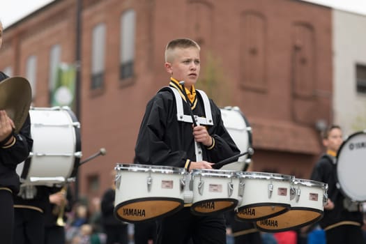 Holland, Michigan, USA - May 12, 2018 Members of the Hamilton Middle School marching band perform at the Muziek Parade, during the Tulip Time Festival