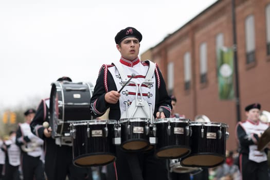 Holland, Michigan, USA - May 12, 2018 Members of the Arlington High School All Brass Marching Band perform at the Muziek Parade, during the Tulip Time Festival
