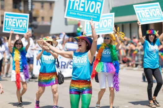 Chicago, Illinois, USA - June 24, 2018 Women promoting candidate Maggie Trevor for State Representative during the LGBTQ Pride Parade in Chicago
