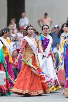 Washington, D.C., USA - July 4, 2018, The National Independence Day Parade, Indian women, dancers, wearing traditional clothing, going down constitution avenue