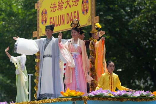 Washington, D.C., USA - July 4, 2018, The National Independence Day Parade, Chinese Women wearing traditional chinese clothing, going down constitution avenue