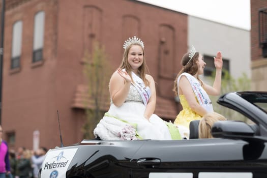 Holland, Michigan, USA - May 12, 2018 Miss Mattawan riding on a car down the road at the Muziek Parade, during the Tulip Time Festival