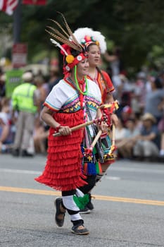 Washington, D.C., USA - July 4, 2018, The National Independence Day Parade, Taiwanese women wearing traditional clothing, walking down constitution avenue during the parade