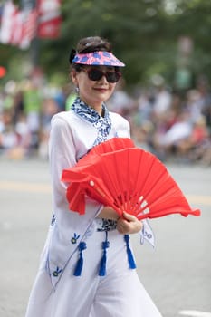 Washington, D.C., USA - July 4, 2018, The National Independence Day Parade, Taiwanese women wearing traditional clothing, walking down constitution avenue during the parade