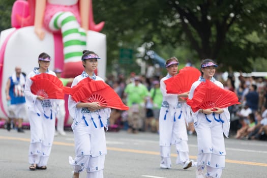 Washington, D.C., USA - July 4, 2018, The National Independence Day Parade, Taiwanese women wearing traditional clothing, walking down constitution avenue during the parade