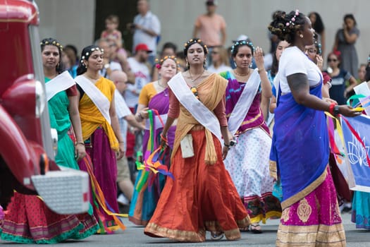 Washington, D.C., USA - July 4, 2018, The National Independence Day Parade, Indian women, dancers, wearing traditional clothing, going down constitution avenue